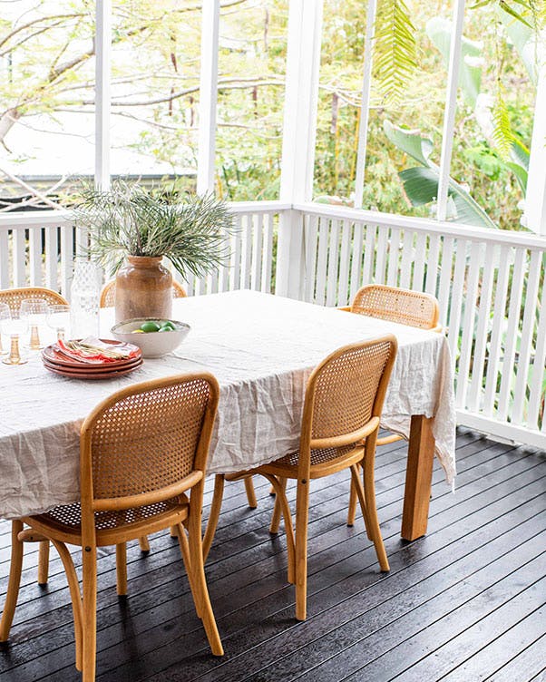 Table and chairs on a deck coated with Feast Watson Timber & Deck Stain in Black Japan