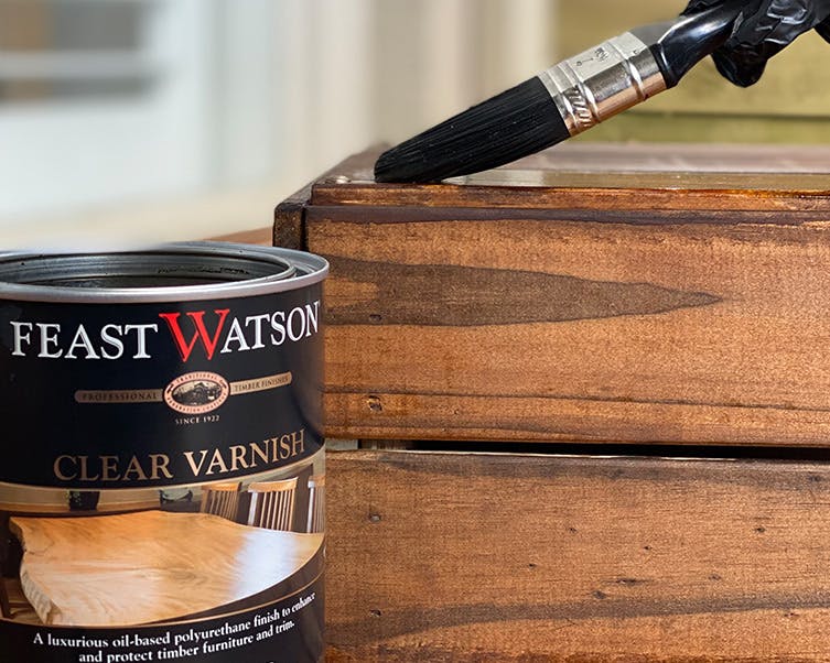 Applying Feast Watson Clear Varnish to a wooden gift hamper crate